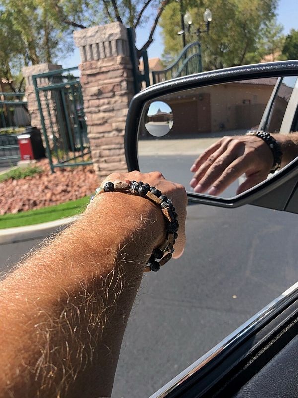 wearing aromatherapy bracelets on arm in car
